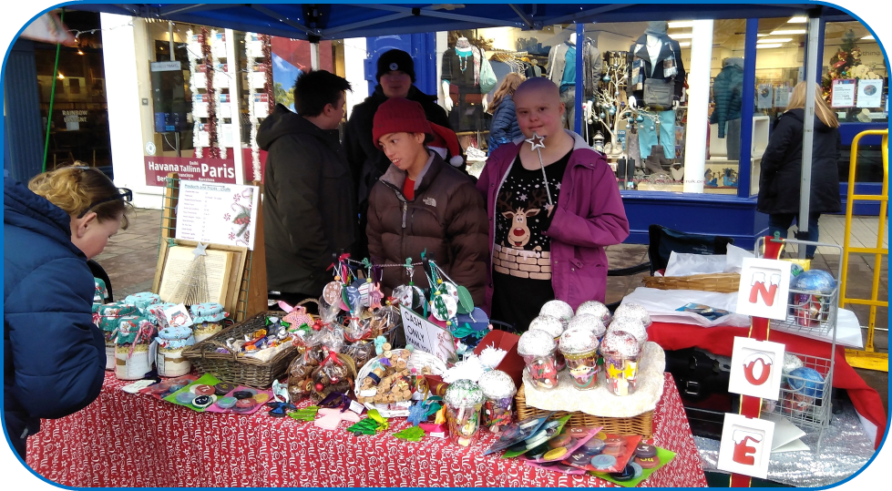 Students running The Castle Stall at Newbury Market