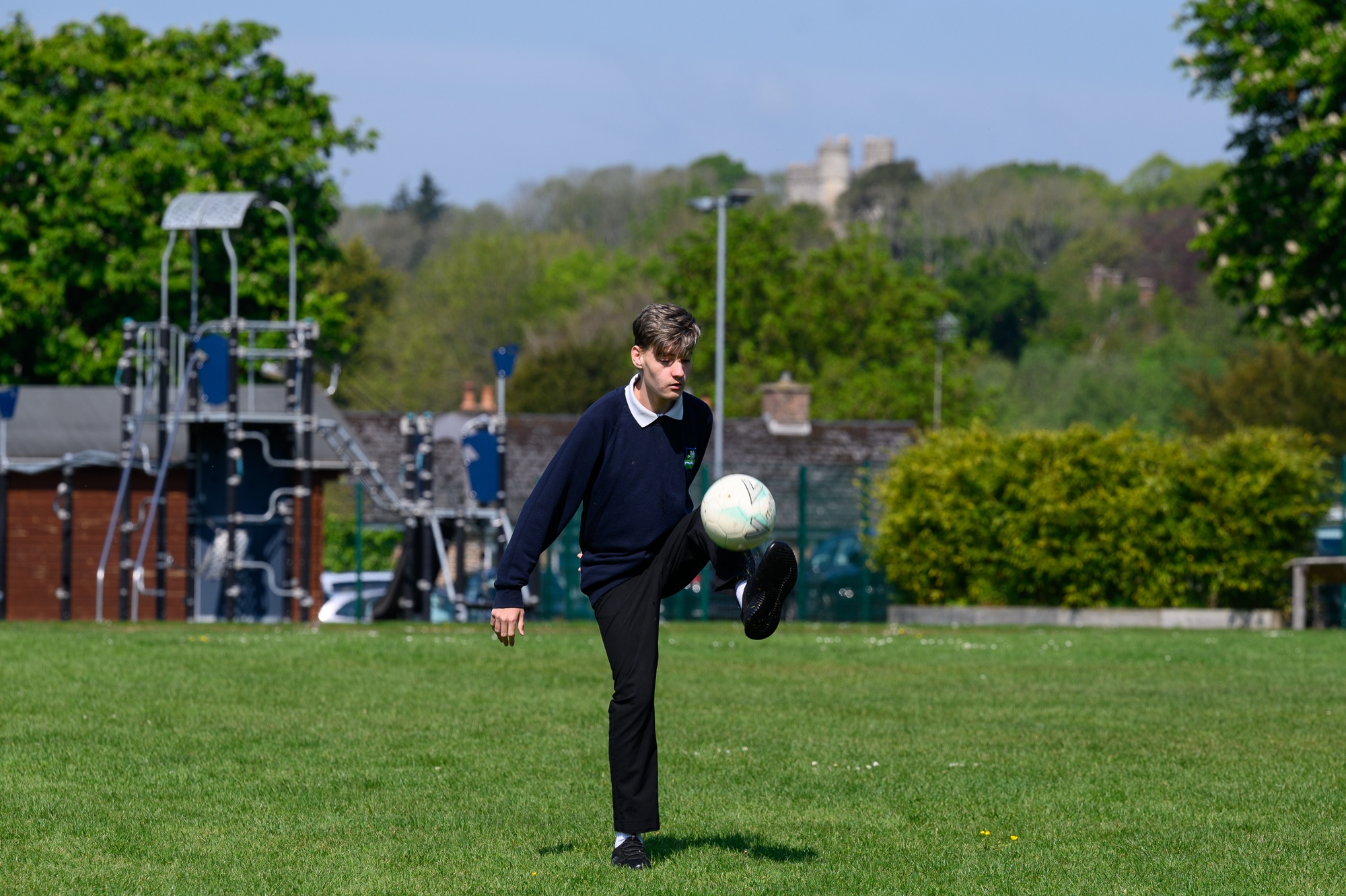 Student kicking a football