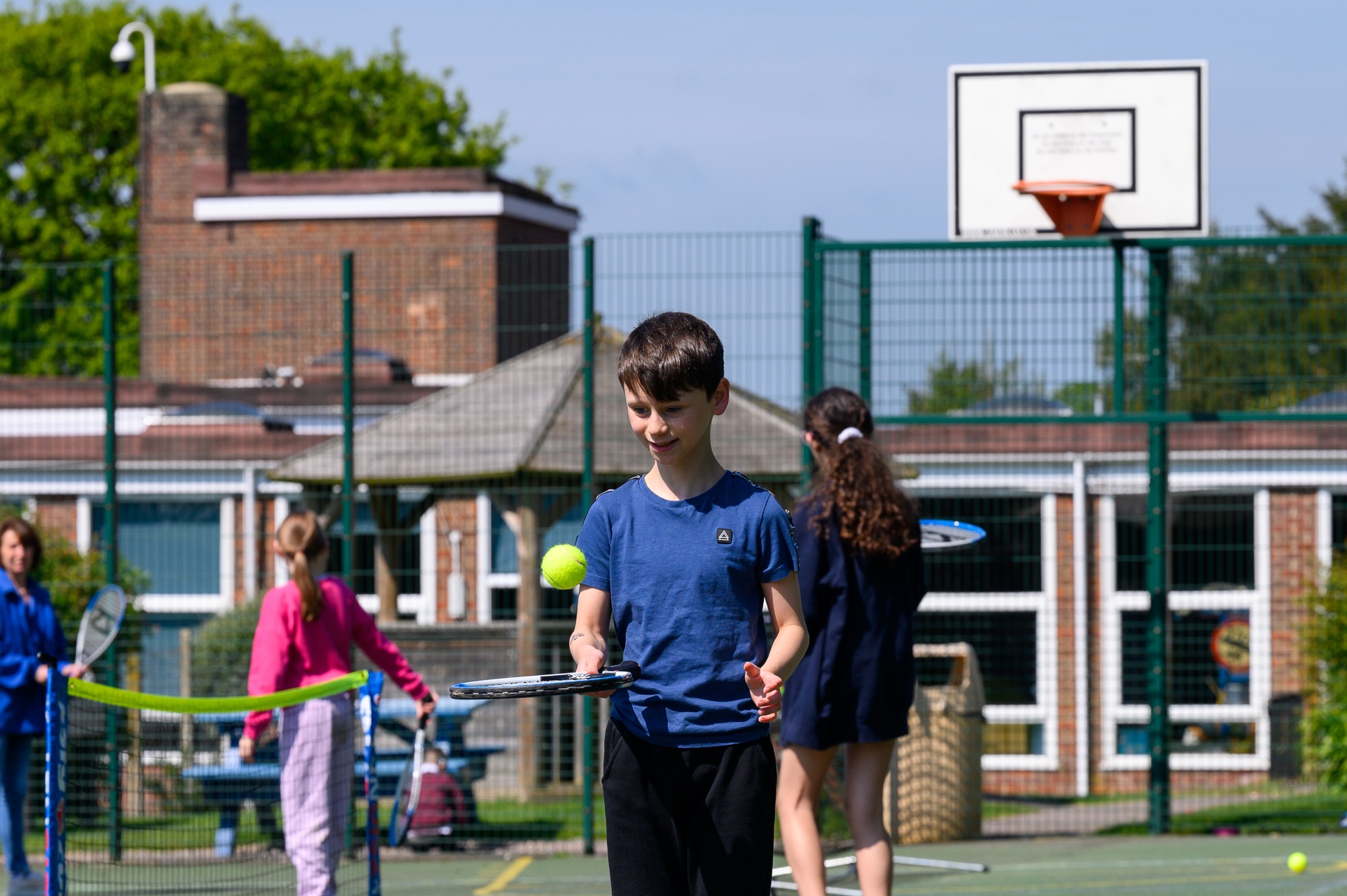 Student bouncing a tennis ball on a raquet